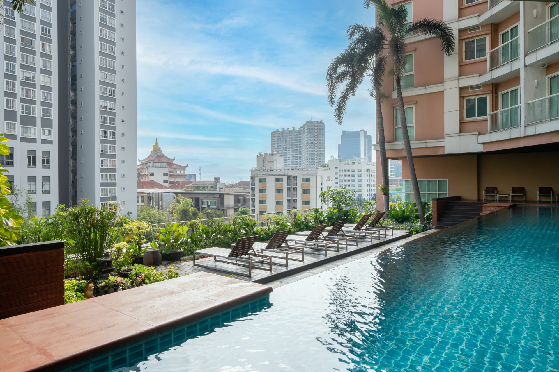 Rooftop swimming pool with sun loungers and city view